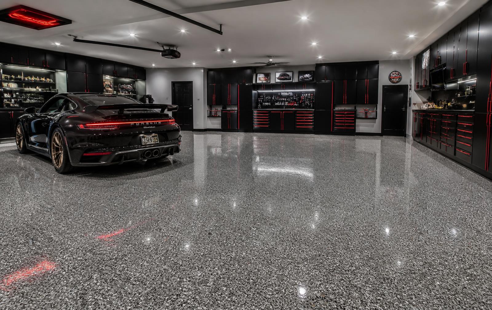 Luxury garage with a glossy quartz epoxy flake floor